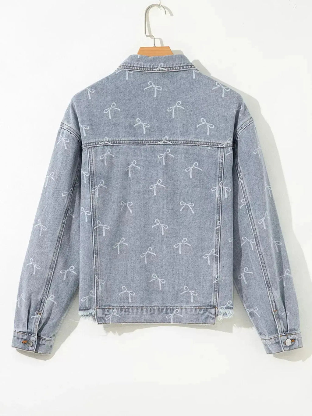 Women’s light wash denim jacket with bow knot print and raw hem, stylish casual denim jacket by Trendsi.