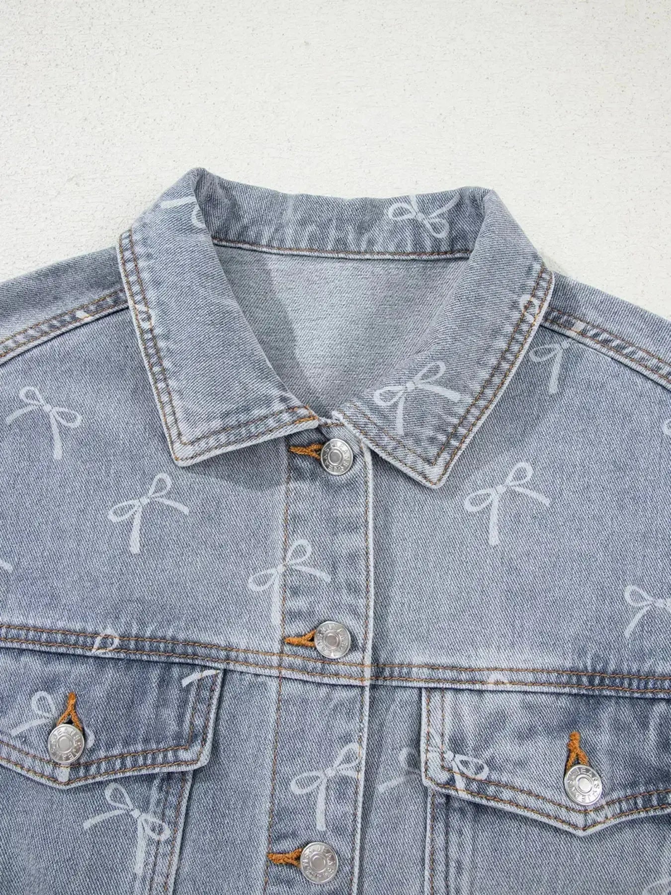 Light wash denim jacket with bow knot print and raw hem, women's fashion denim jacket by Trendsi.
