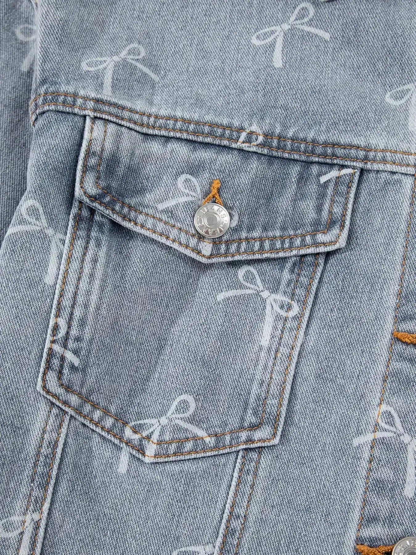 Woman wearing a light wash denim jacket with bow knot print, raw hem, and casual fit from Trendsi.