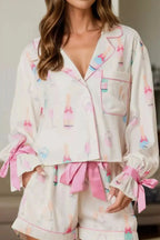 Women's bow print collared lounge top and drawstring shorts pajama set by Trendsi, featuring soft fabric and comfortable fit.