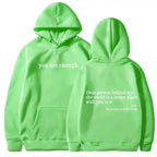 Women’s brushed fleece hoodie with letter graphic from Plush Fashion Hub, soft oversized pullover in a cozy, casual style.