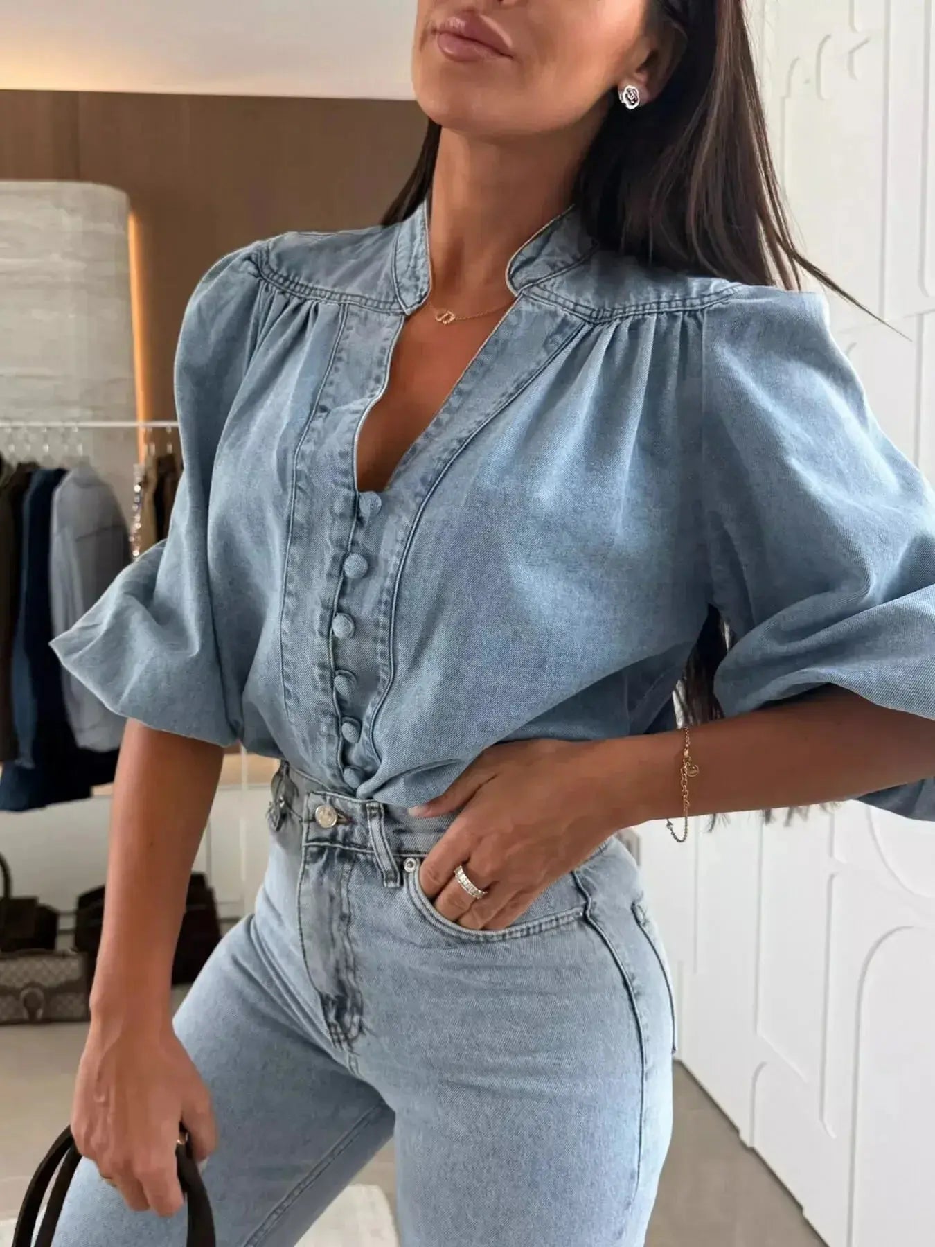 Women's button-down puff sleeve denim blouse by Trendsi, featuring a structured casual chic style with classic denim fabric.