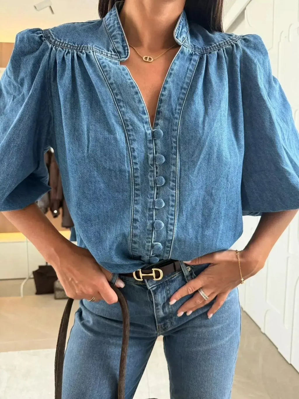 Women's button-down puff sleeve denim blouse by Trendsi featuring structured casual chic style and classic denim fabric.