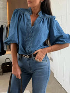 Women’s button-down puff sleeve denim blouse featuring structured design and casual chic style by Trendsi.