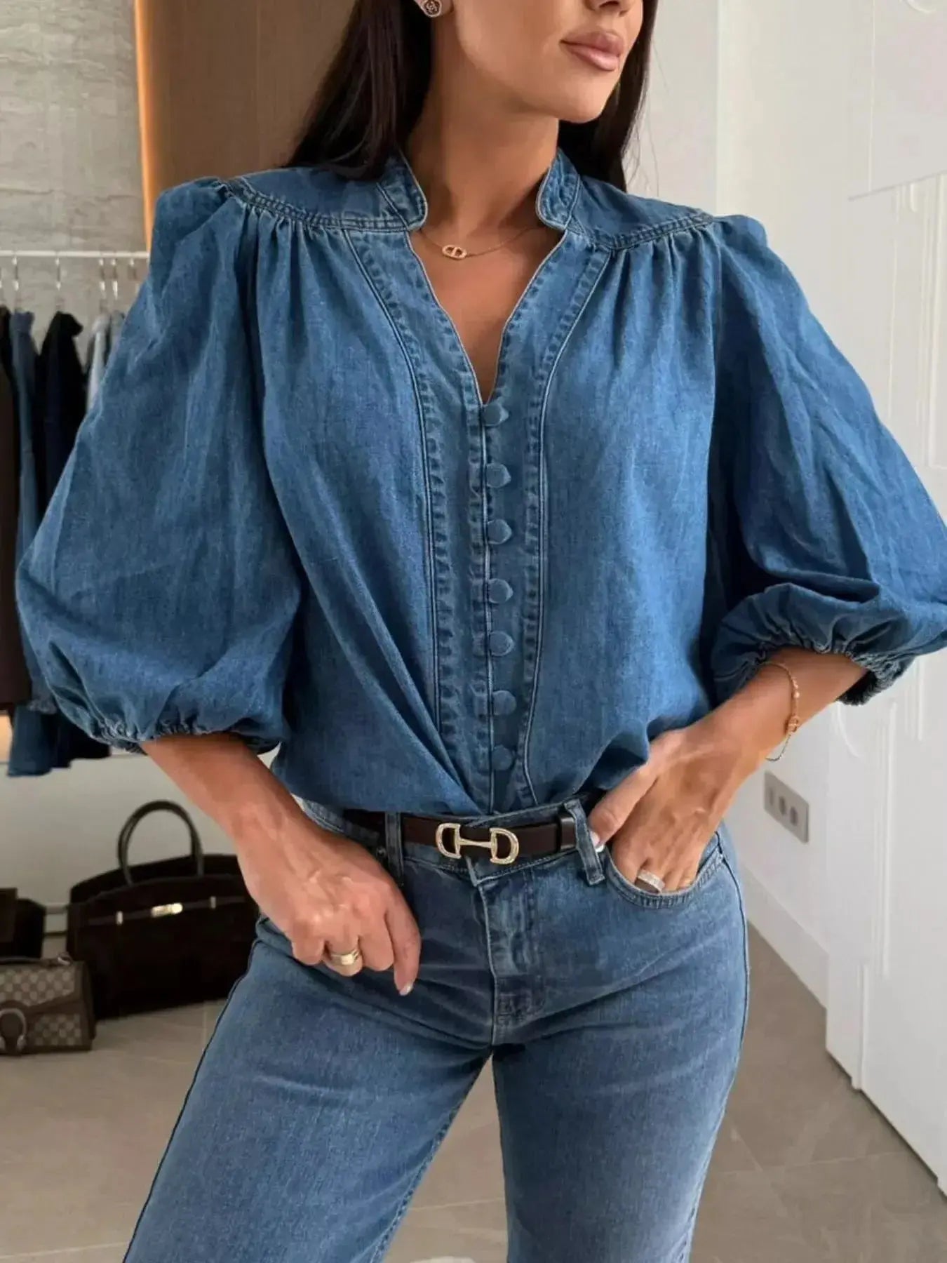 Women's button-down puff sleeve denim blouse by Trendsi, featuring structured casual chic design and classic denim fabric.