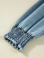 Women's casual denim shirt dress with button-up front and smocked cuffs, stylish Trendsi denim dress for everyday wear.