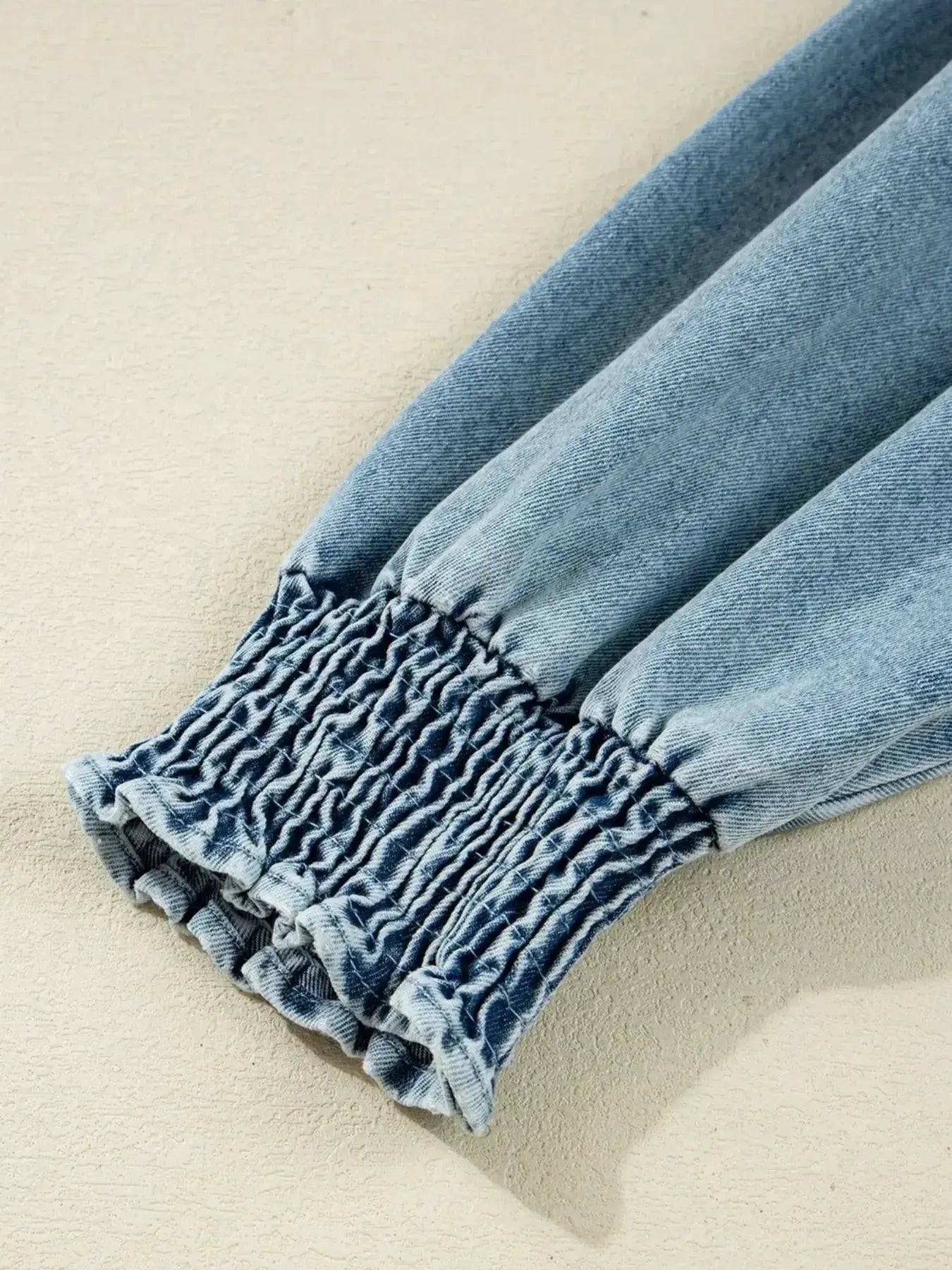 Women's casual denim shirt dress with button-up front and smocked cuffs, stylish Trendsi denim dress for everyday wear.
