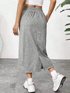 Women’s casual drawstring midi skirt with pockets and side slit, trendy skirt in soft fabric for everyday wear.