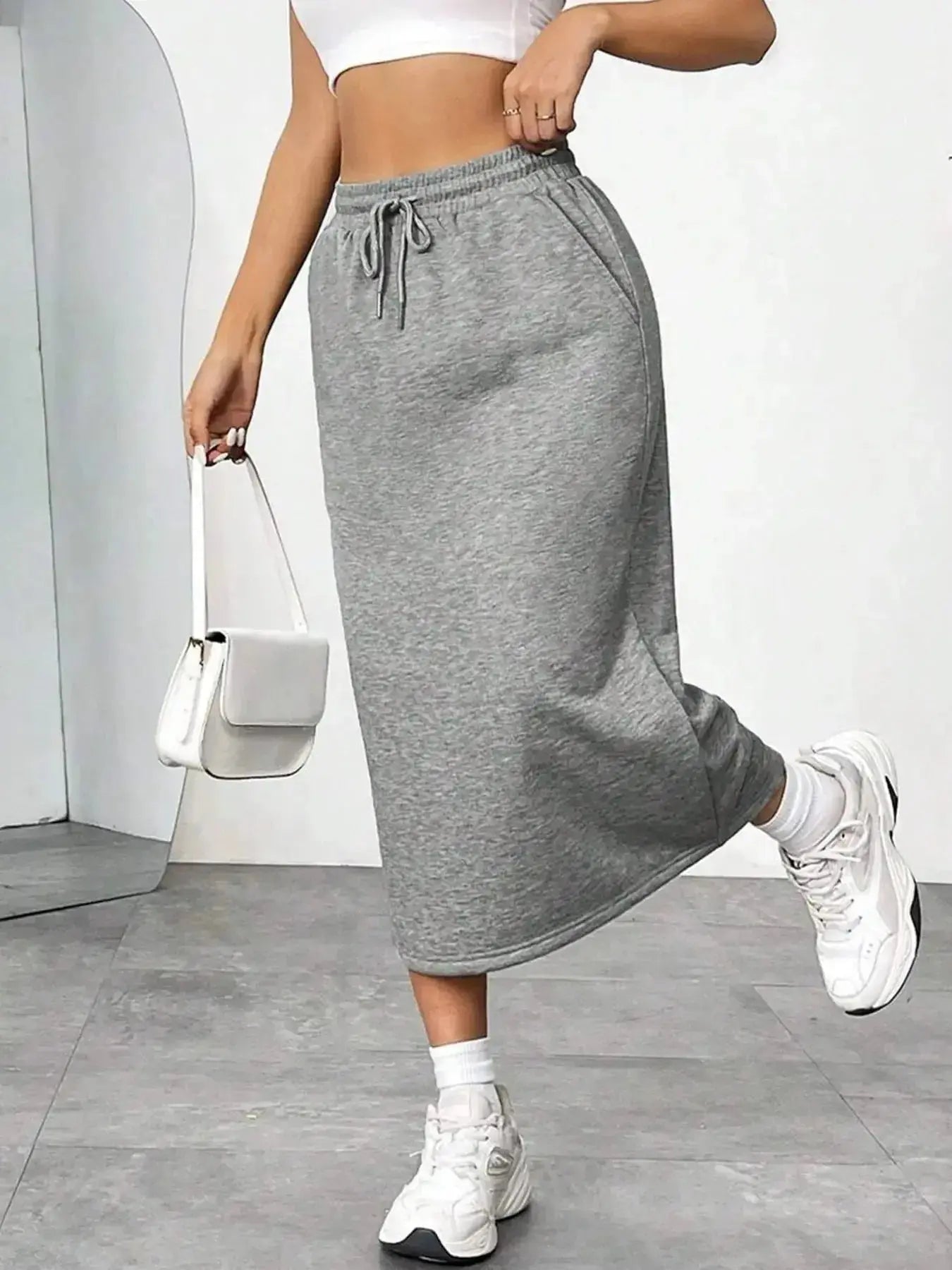 Women’s casual drawstring midi skirt with pockets and side slit, trendy and comfortable for everyday wear.