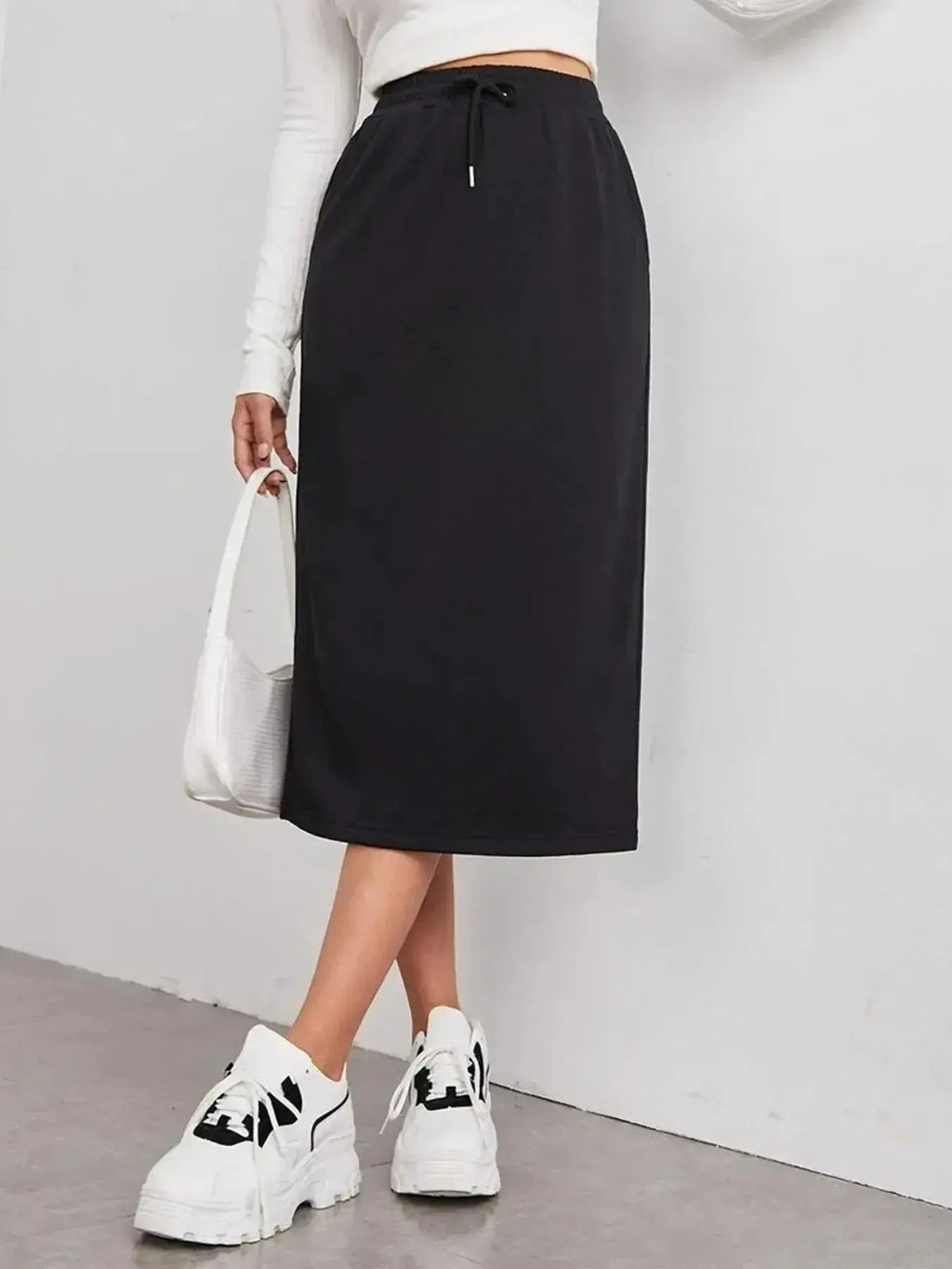 Women's casual drawstring midi skirt with pockets and side slit, made by Trendsi, shown in a relaxed, stylish fit.