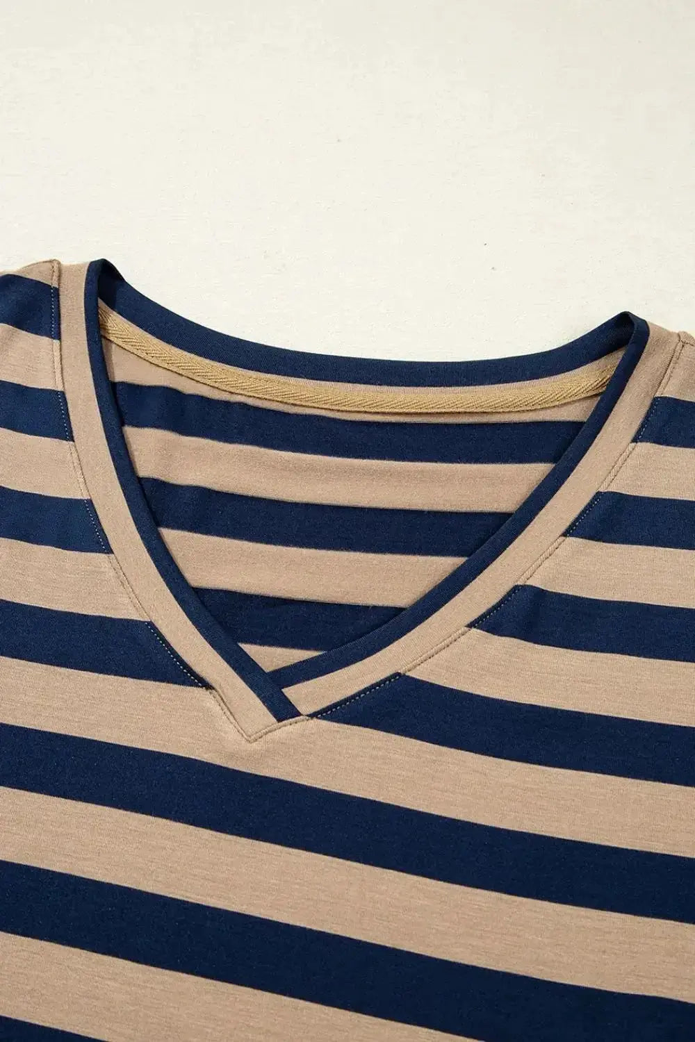 Women wearing a striped V-neck midi T-shirt dress by Plush Fashion Hub, casual style with a relaxed fit and mid-length design.