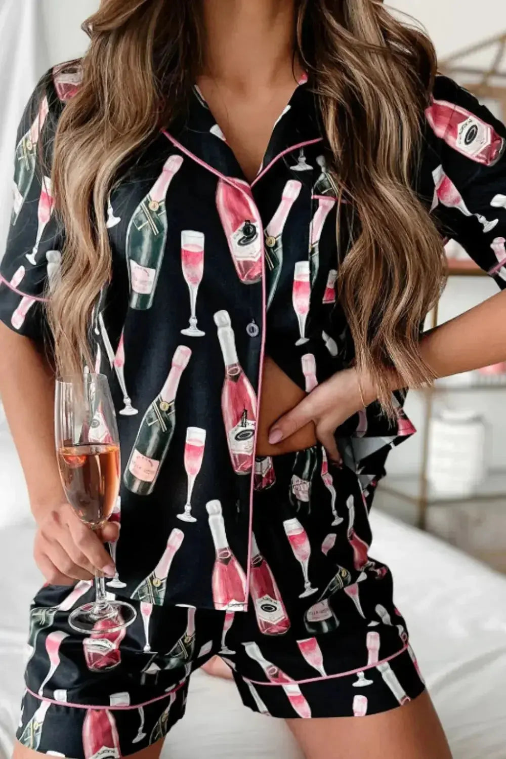 Women's champagne print short sleeve pajama top and shorts lounge set by Trendsi, featuring a relaxed fit and playful design.