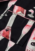Women's champagne print short sleeve pajama top and shorts lounge set by Trendsi, soft fabric, relaxed fit, perfect for comfortable sleepwear.