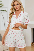 Women's cheery print collared pajama top and shorts lounge set by Trendsi, featuring button-down design and comfortable fit.