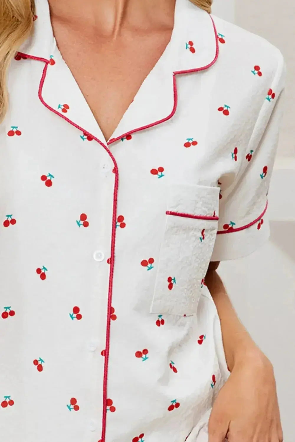 Women's cheery print pajama set with collared button-down top and shorts from Trendsi, perfect for comfortable lounge wear.