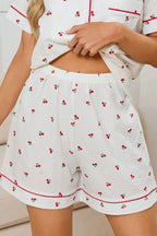 Women's cheery print pajama set with collared button-down top and matching shorts by Trendsi, perfect for comfortable lounging.