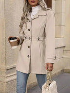 Women's classic button-front long sleeve layering coat, trendy transitional outerwear by Trendsi on a model.