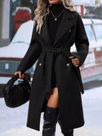 Women's double-breasted trench coat with tie waist belt, stylish outerwear from Trendsi, featuring classic design and neutral color.