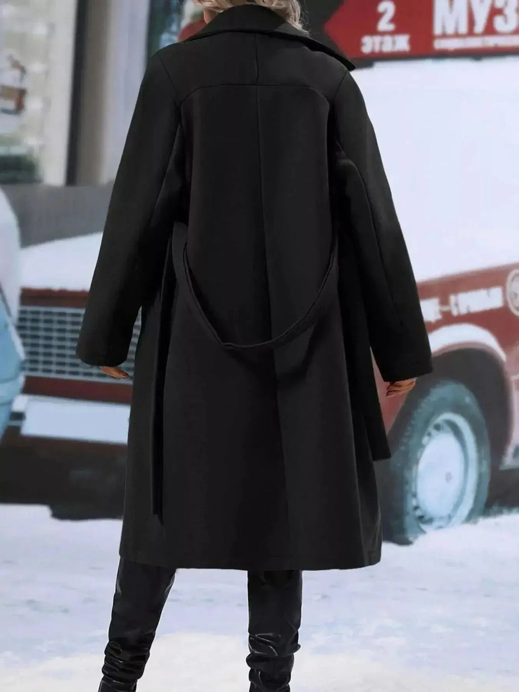 Women’s double-breasted trench coat by Trendsi with tie waist belt, shown in a stylish outdoor setting.