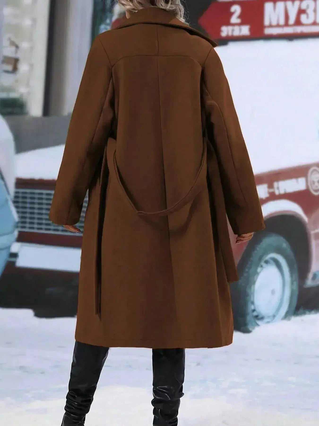 Women’s double-breasted trench coat from Trendsi featuring a tie waist belt and classic design, shown on a model.