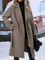 Women’s double-breasted trench coat with tie waist belt, stylish outerwear by Trendsi, shown on a model in a city setting.