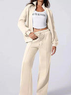 Women's drop shoulder zip-up jacket and jogger lounge set by Trendsi, shown in soft fabric with relaxed fit for comfortable style.