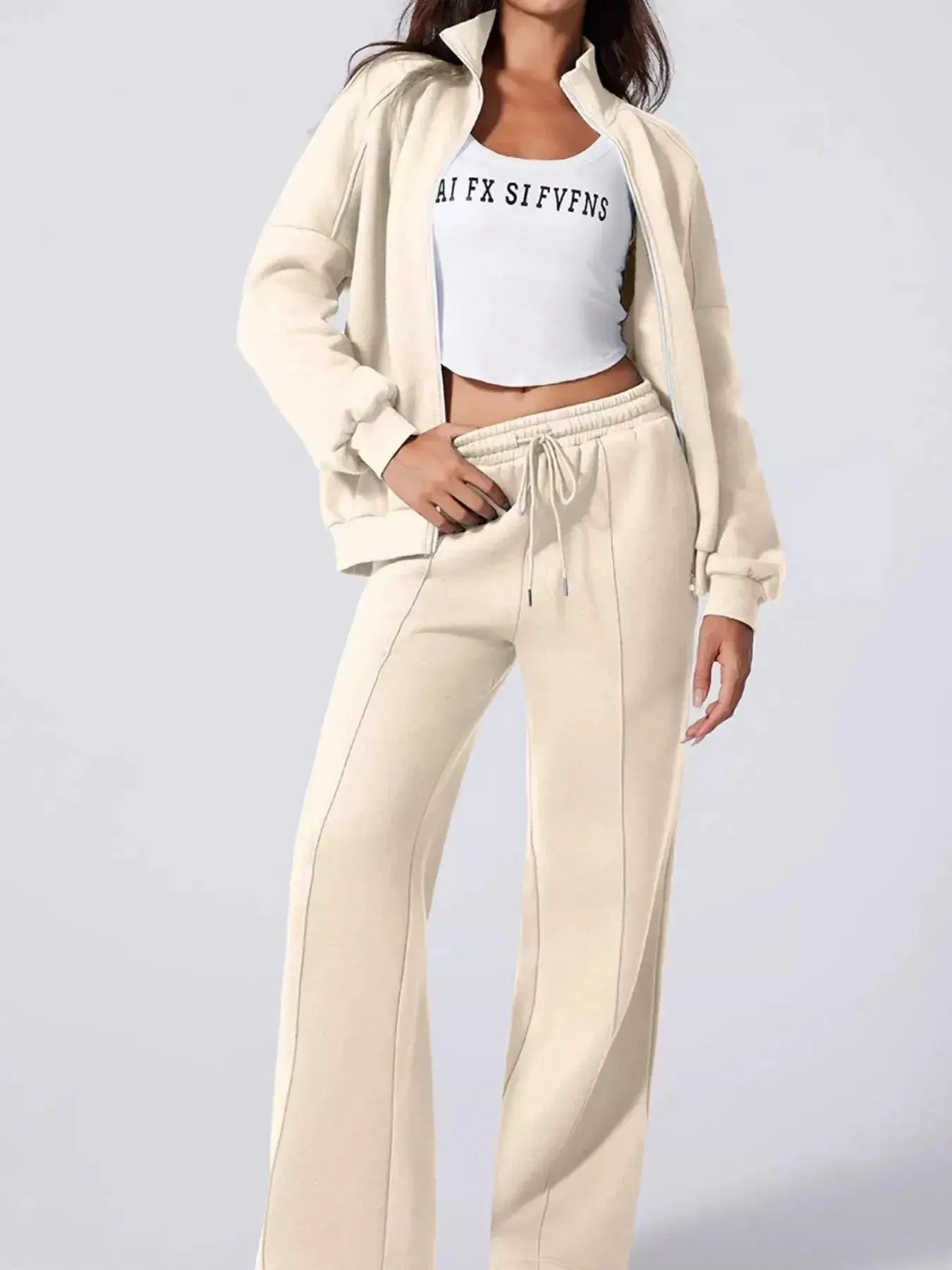Women's drop shoulder zip-up jacket and jogger lounge set by Trendsi, shown in soft fabric with relaxed fit for comfortable style.