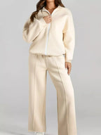 Women’s drop shoulder zip-up jacket and jogger two-piece lounge set by Trendsi, featuring a cozy sweat suit in relaxed fit.