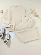 Women’s drop shoulder zip-up jacket and jogger lounge set by Trendsi, casual two-piece sweat suit with relaxed fit and cozy fabric.