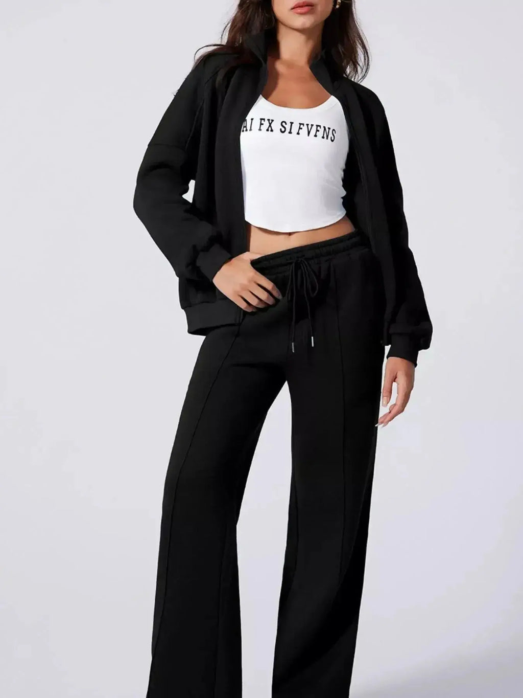 Women’s drop shoulder zip-up jacket and jogger lounge set by Trendsi, soft fabric, casual two-piece sweat suit for comfort.