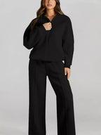 Women's drop shoulder zip-up jacket and jogger sweat suit set by Trendsi, featuring a relaxed fit and comfortable lounge style.