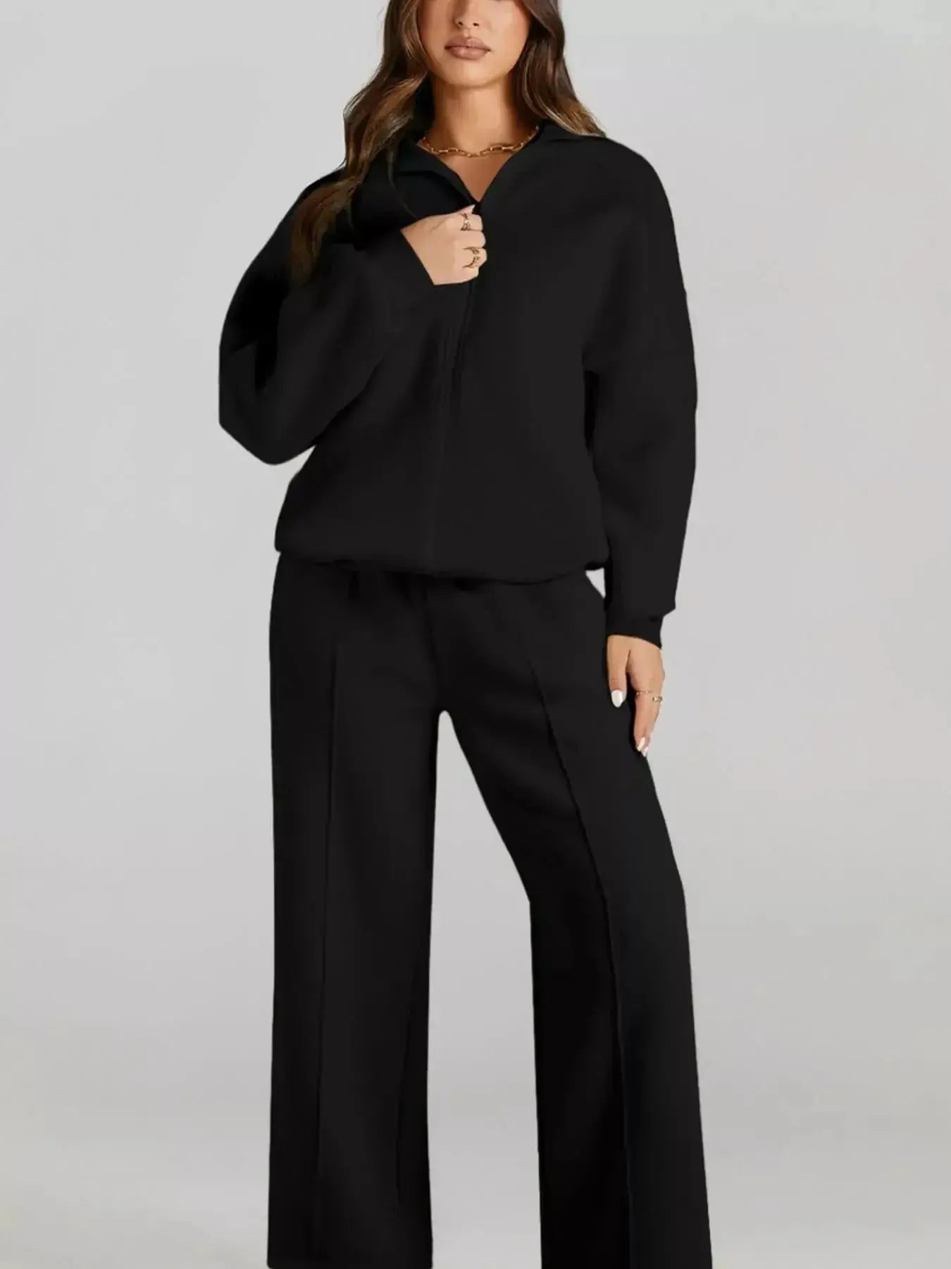 Women's drop shoulder zip-up jacket and jogger sweat suit set by Trendsi, featuring a relaxed fit and comfortable lounge style.