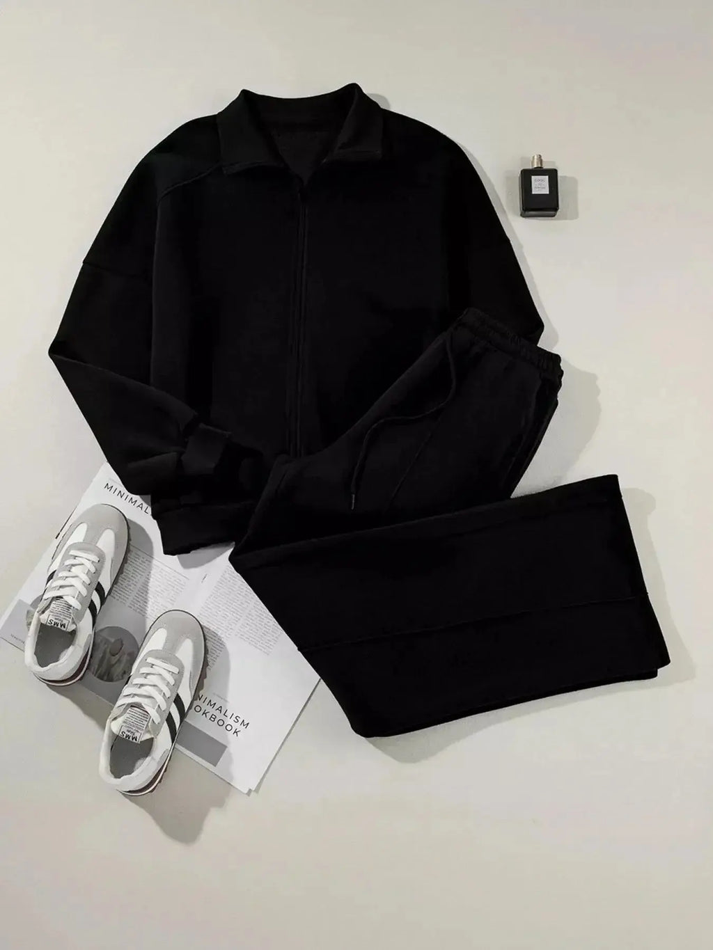 Women’s drop shoulder zip-up jacket and jogger lounge set, stylish two-piece sweat suit by Trendsi, with cozy fabric and casual fit.