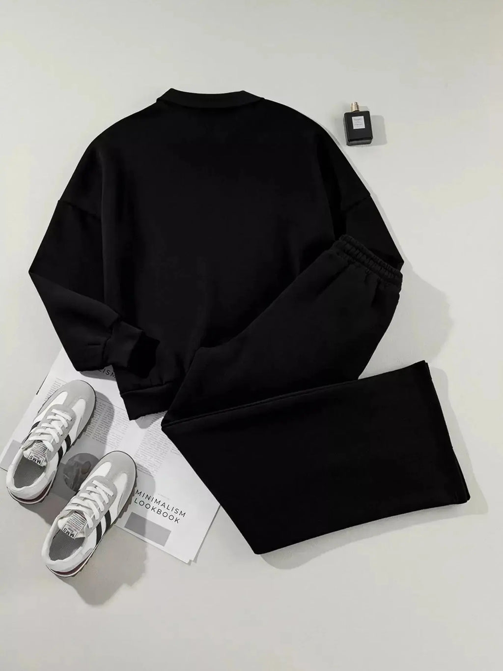 Women’s drop shoulder zip-up jacket and jogger two-piece lounge set by Trendsi, featuring a cozy sweat suit with relaxed fit and casual style.