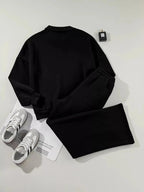 Women’s drop shoulder zip-up jacket and jogger two-piece lounge set by Trendsi, featuring a cozy sweat suit with relaxed fit and casual style.