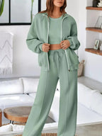 Women’s drop shoulder zip-up jacket and jogger lounge set by Trendsi, casual sweat suit for comfortable everyday wear.