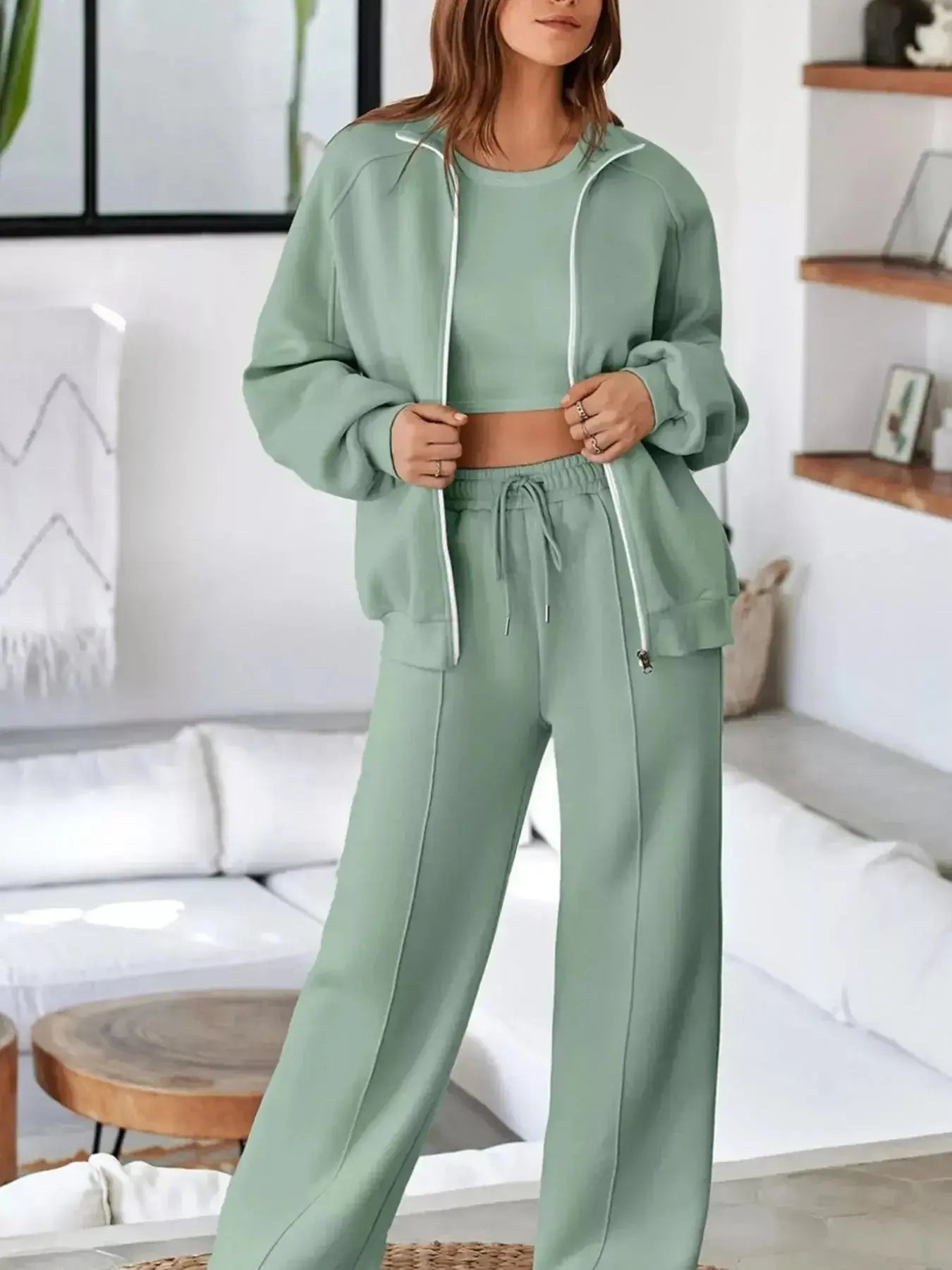 Women’s drop shoulder zip-up jacket and jogger lounge set by Trendsi, casual sweat suit for comfortable everyday wear.