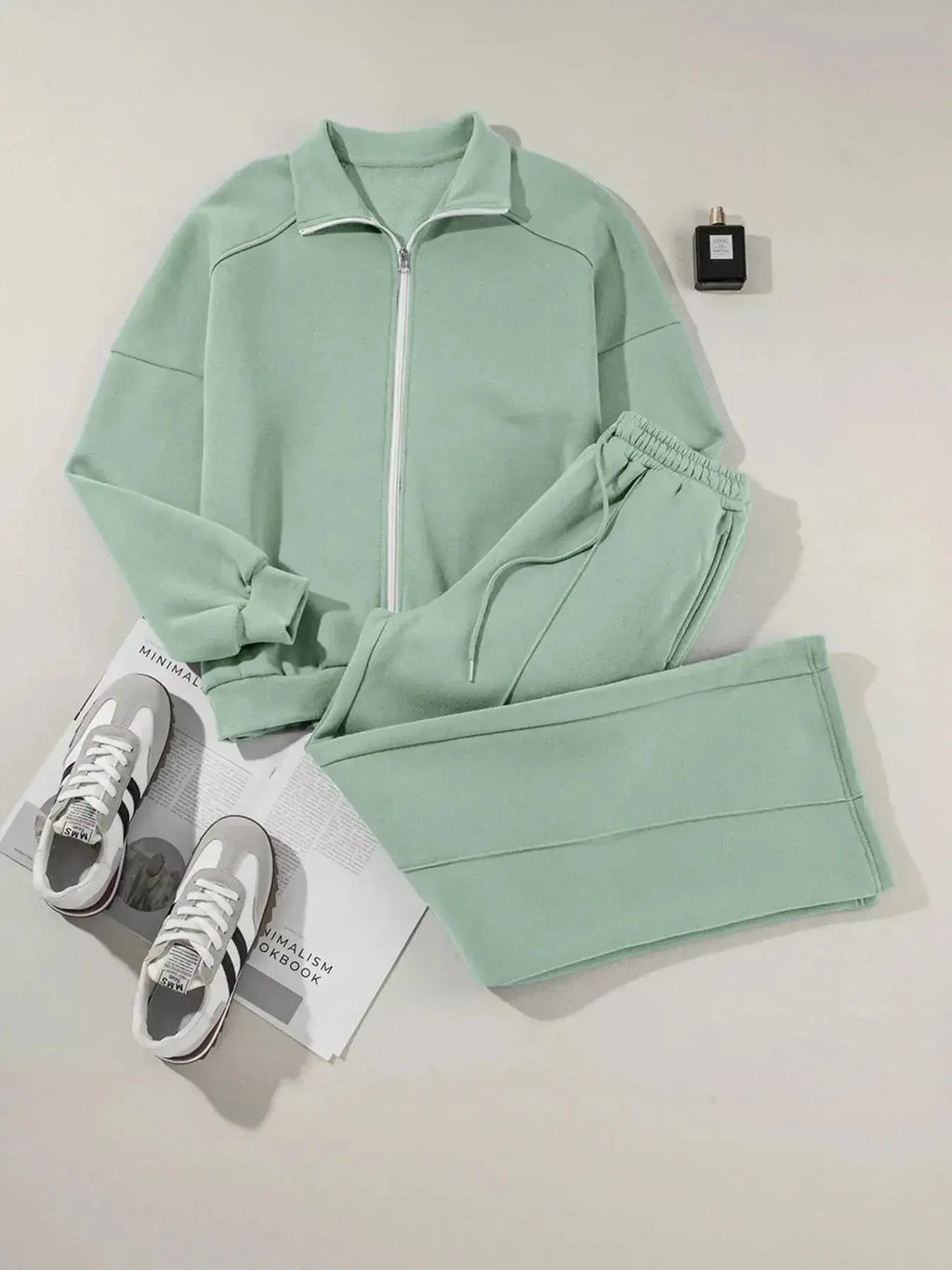 Women's drop shoulder zip-up jacket and jogger sweat suit two-piece lounge set by Trendsi, featuring a cozy, casual fit.