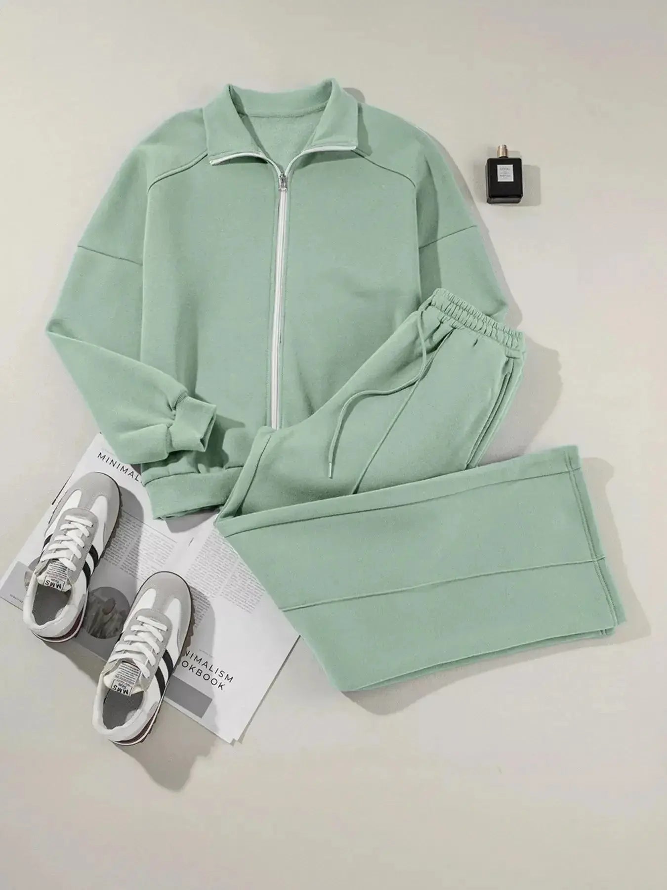 Women's drop shoulder zip-up jacket and jogger sweat suit two-piece lounge set by Trendsi, featuring a cozy, casual fit.