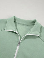 Women's drop shoulder zip-up jacket and jogger sweat suit two-piece lounge set by Trendsi, featuring a relaxed fit and comfortable fabric.