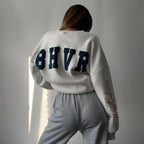 Women wearing a soft round neck casual sweater from Plush Fashion Hub, featuring a cozy, relaxed fit in the image.