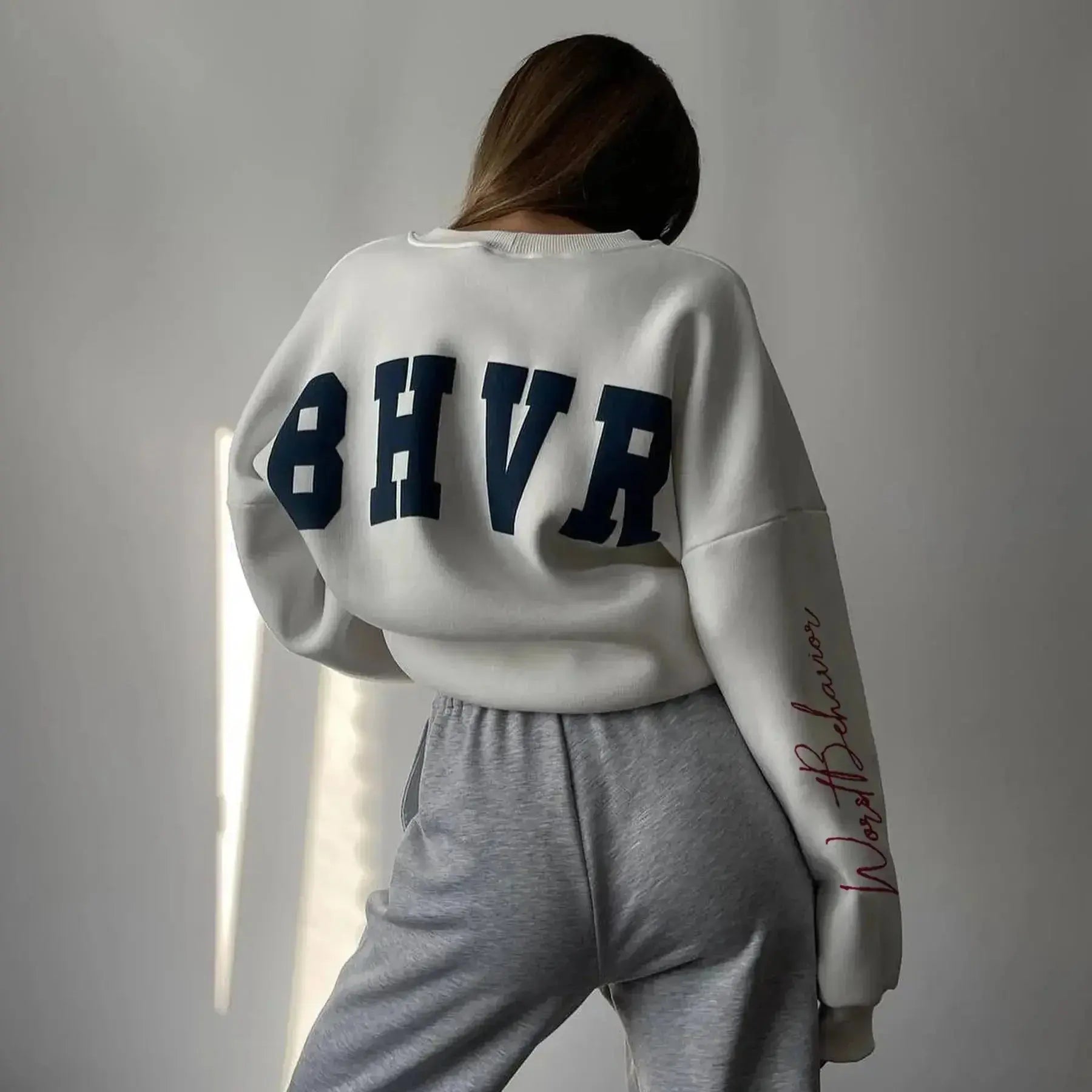 Women wearing a soft round neck casual sweater from Plush Fashion Hub, featuring a cozy, relaxed fit in the image.