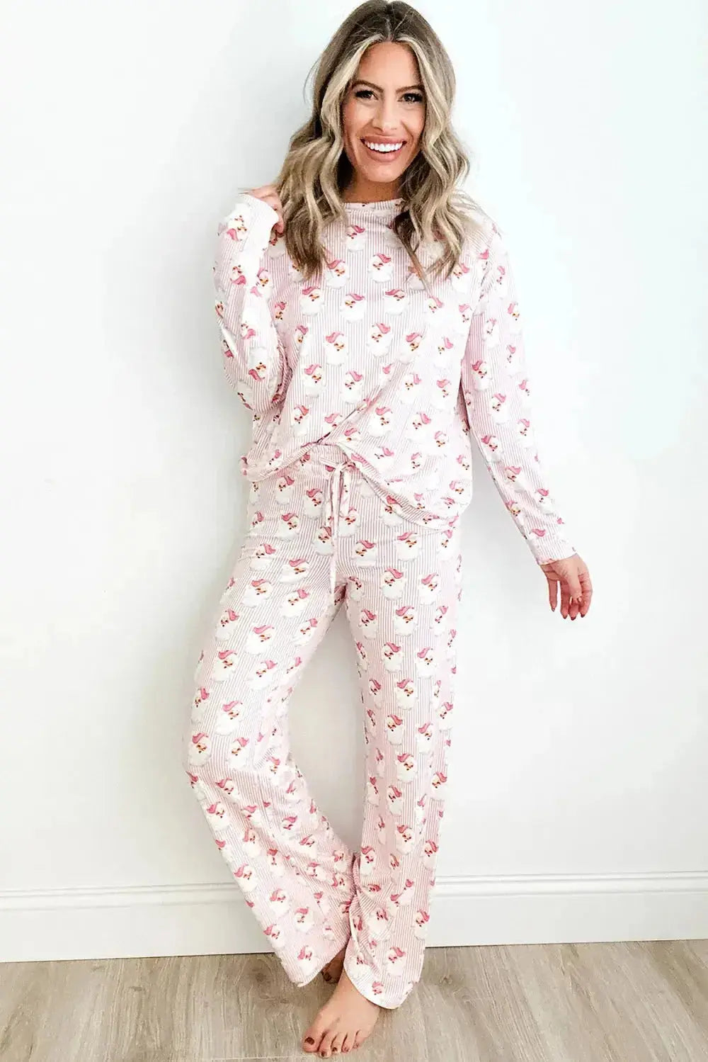 Women wearing Plush Fashion Hub Santa print long sleeve pajama lounge set, festive holiday pajamas for women.