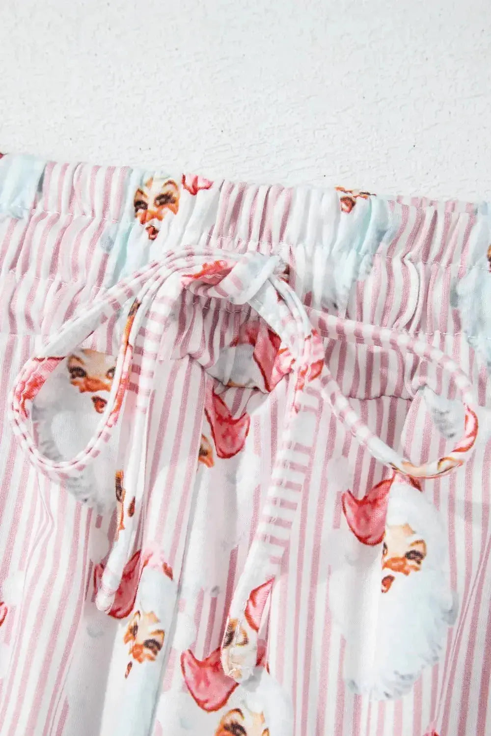Women's festive Santa print long sleeve pajama lounge set by Plush Fashion Hub, featuring cozy holiday-themed pajamas with Santa design.
