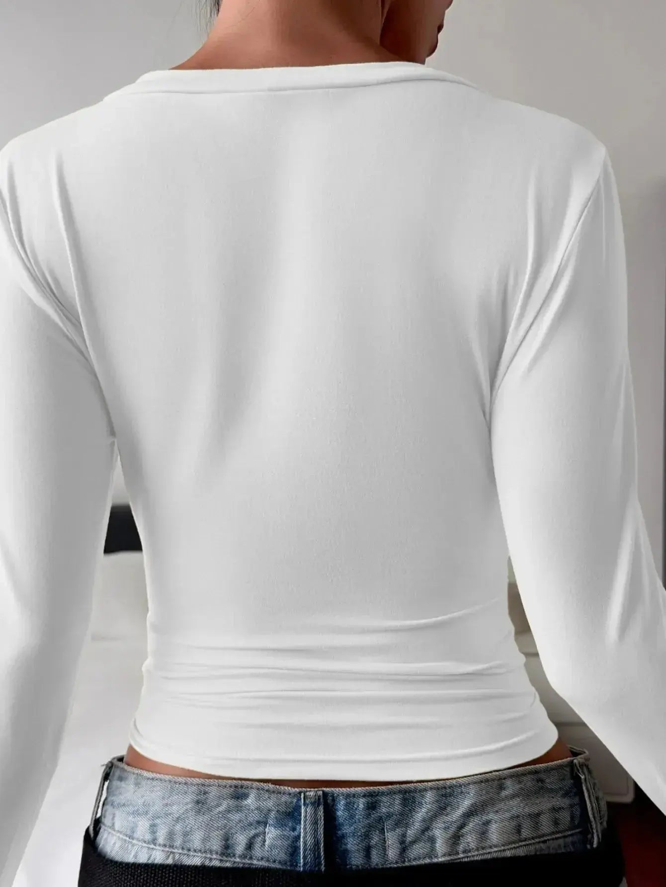 Women's fitted V-neck long sleeve T-shirt by Trendsi, showing a casual, comfortable design in a neutral color.