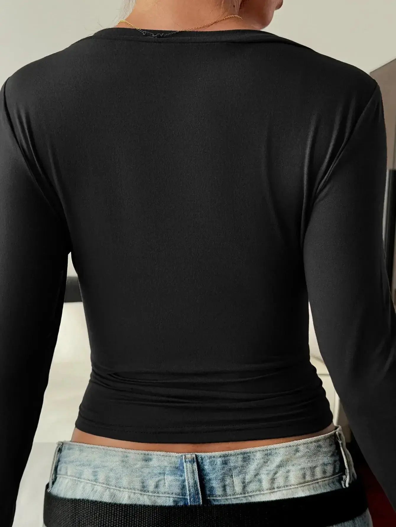 Women’s fitted V-neck long sleeve essential T-shirt by Trendsi, shown in a natural fit and classic V-neck style.