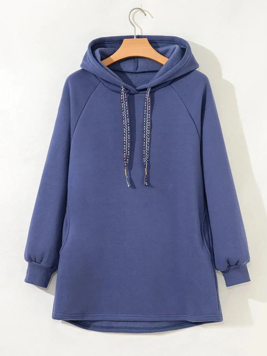 Women’s fleece-lined oversized tunic hoodie with drawstring hood, cozy and relaxed fit, from Trendsi.