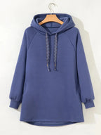Women’s fleece-lined oversized tunic hoodie with drawstring hood, cozy and relaxed fit, from Trendsi.