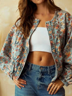 Women’s floral print cropped denim jacket by Trendsi, featuring a zip-up design and cotton blend utility coat style.