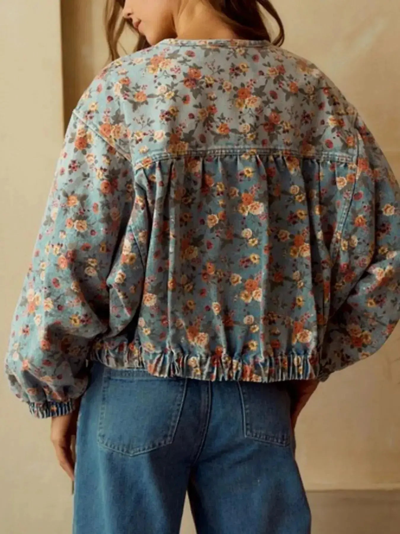 Women's floral print cropped denim jacket with zip-up front, cotton blend fabric, styled as a trendy utility coat.